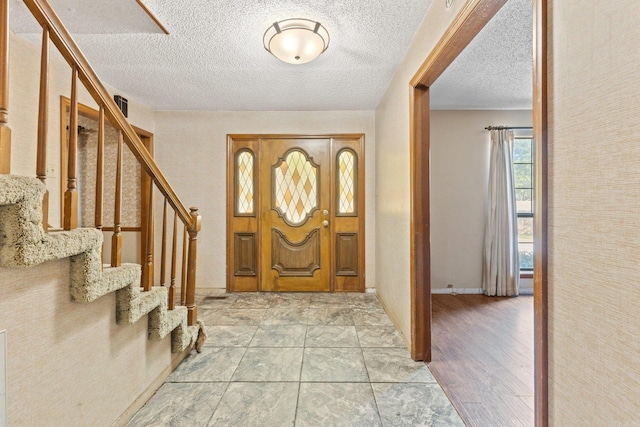 entrance foyer with a textured ceiling and light wood-type flooring