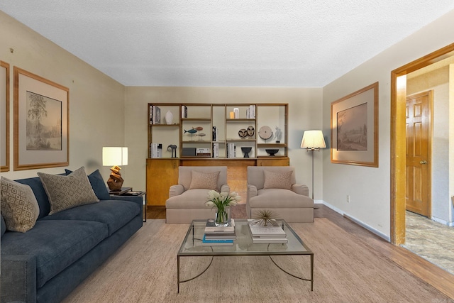 living room featuring a textured ceiling and light colored carpet