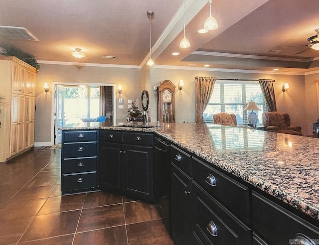 kitchen featuring a wealth of natural light, ornamental molding, dark tile patterned floors, and ceiling fan