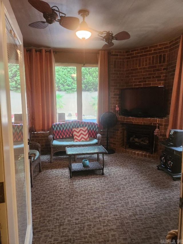 living room with ceiling fan, carpet, and a brick fireplace