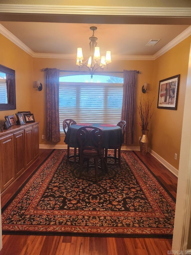 dining area featuring an inviting chandelier, crown molding, and wood-type flooring