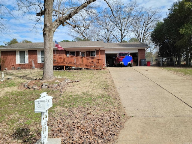 ranch-style home with a front lawn, a wooden deck, and a garage