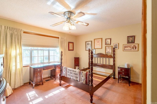 carpeted bedroom featuring a textured ceiling and ceiling fan