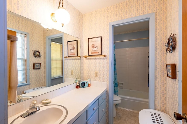 full bathroom featuring vanity, shower / tub combo with curtain, and toilet