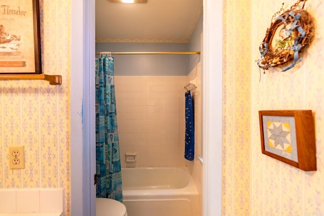 bathroom featuring toilet and shower / bath combo