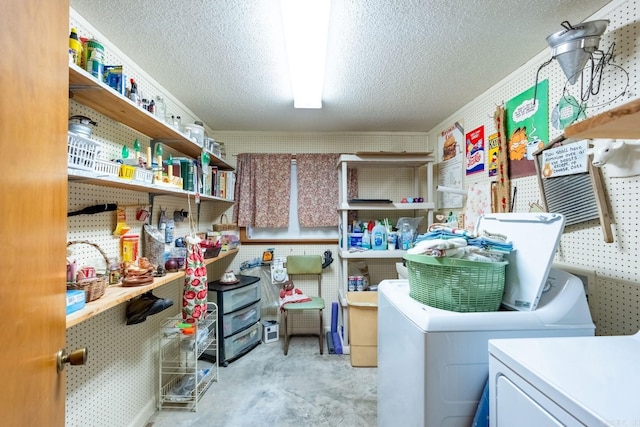 laundry area with light carpet, washing machine and dryer, and a textured ceiling