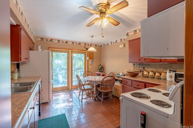 kitchen featuring sink, white appliances, backsplash, and ceiling fan