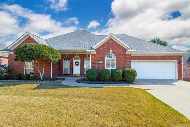 view of front of house featuring a garage and a front lawn