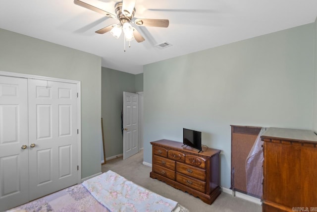 bedroom featuring light carpet, a closet, and ceiling fan