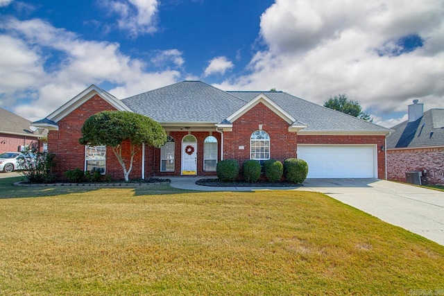 view of front of home with a front yard and a garage