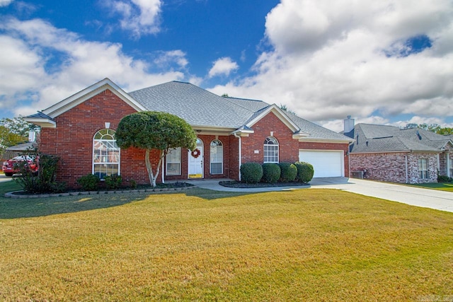 view of front of home with a front yard and a garage