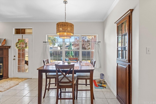 dining area featuring ornamental molding and light tile patterned floors