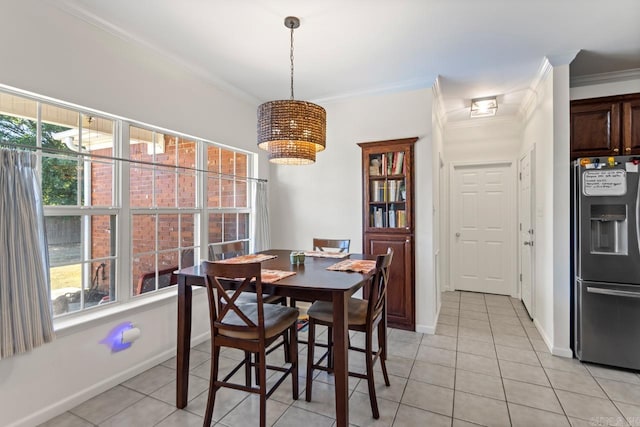 tiled dining room featuring crown molding