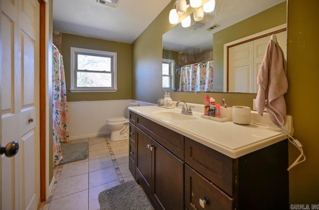 bathroom with vanity, toilet, and tile patterned flooring