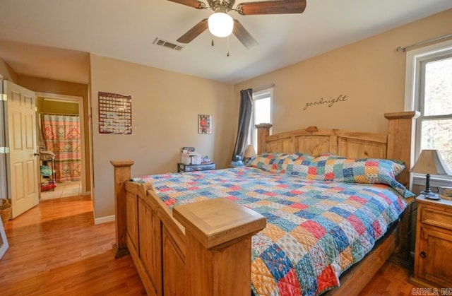 bedroom with light hardwood / wood-style flooring, multiple windows, and ceiling fan