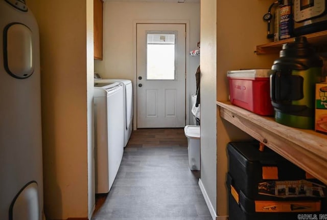 clothes washing area with dark hardwood / wood-style floors and separate washer and dryer