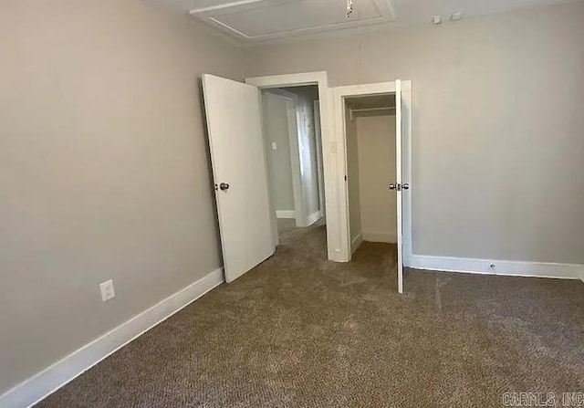 unfurnished bedroom with dark carpet