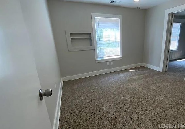 carpeted spare room with ceiling fan