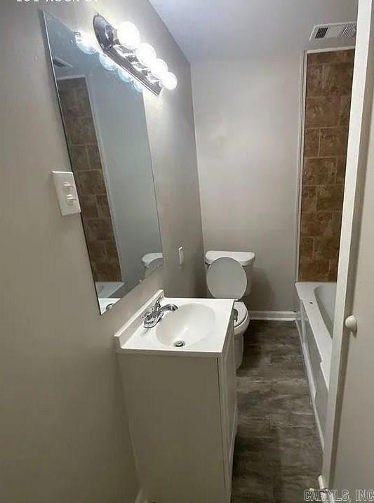 full bathroom with vanity, toilet, and shower / washtub combination