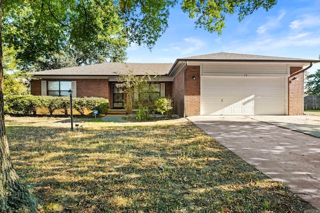 single story home with a front yard and a garage