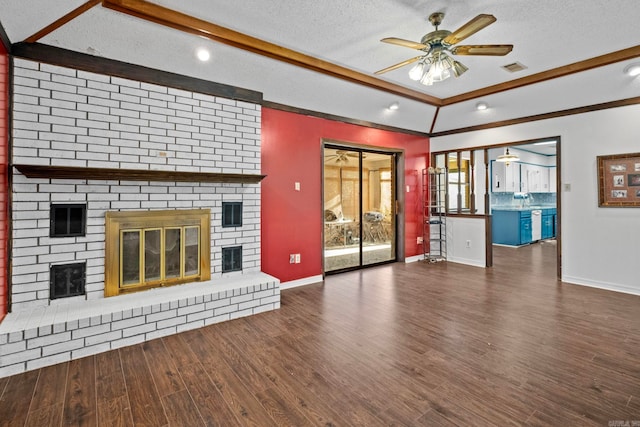 unfurnished living room featuring a textured ceiling, ceiling fan, dark wood-type flooring, and a brick fireplace