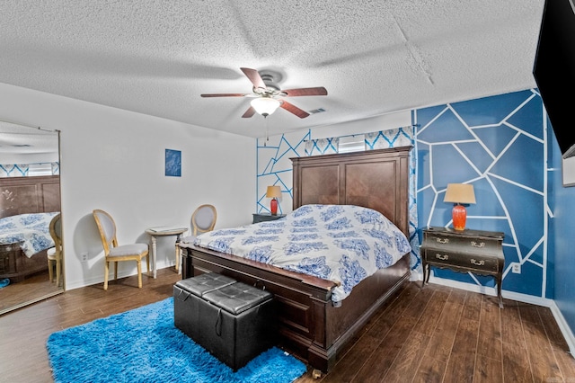 bedroom with ceiling fan, a textured ceiling, and dark hardwood / wood-style floors