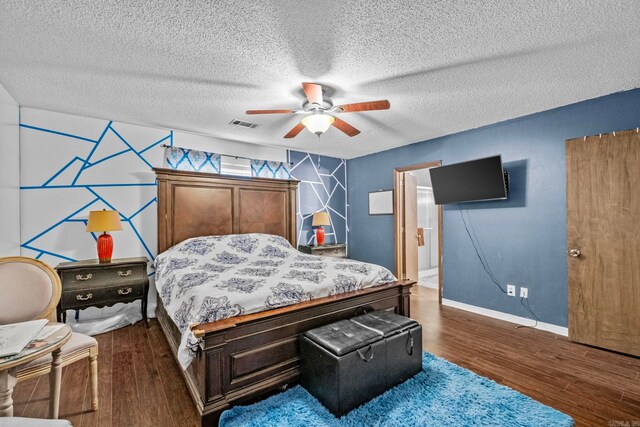 bedroom with a textured ceiling, ceiling fan, ensuite bath, and dark hardwood / wood-style flooring