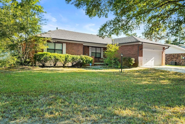 ranch-style home featuring a front yard, a garage, and cooling unit