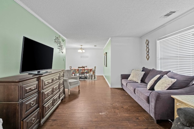 living room with ornamental molding, a textured ceiling, and dark hardwood / wood-style flooring