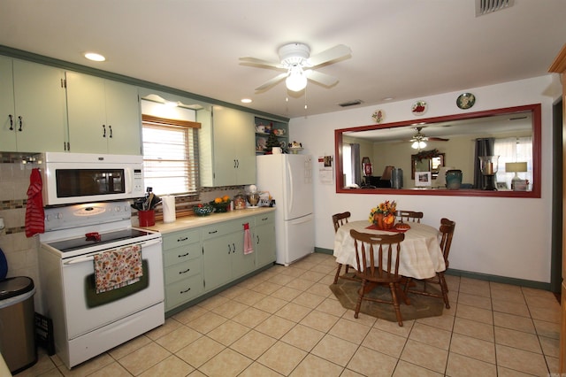 kitchen with backsplash, light tile patterned floors, white appliances, and ceiling fan