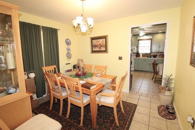 dining room featuring ceiling fan with notable chandelier and light tile patterned floors