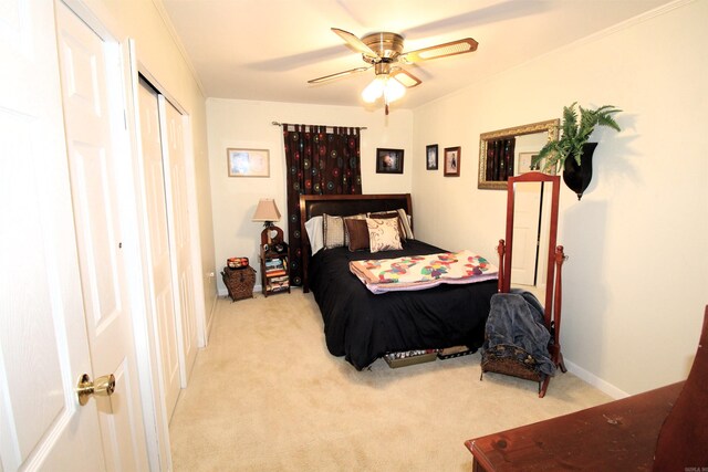 bedroom with ornamental molding, light colored carpet, and ceiling fan