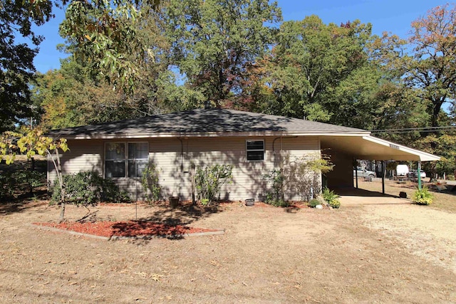 view of front of property featuring an attached carport and driveway