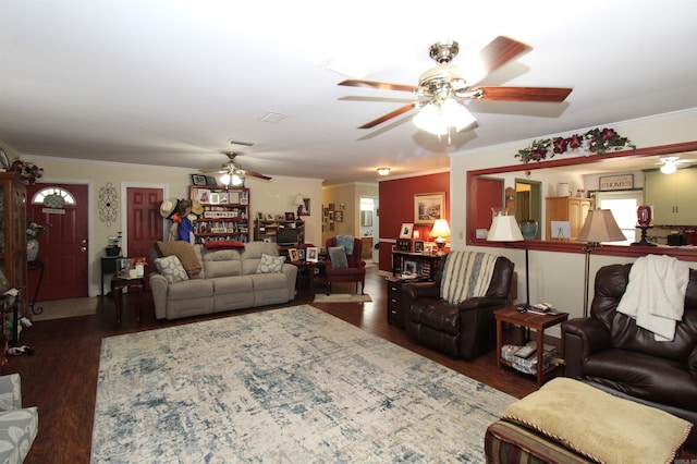 living area with crown molding, ceiling fan, and wood finished floors