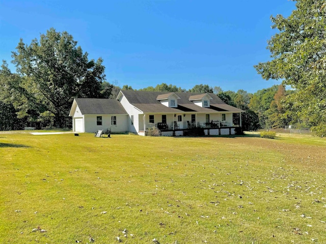 rear view of property featuring a yard and a garage