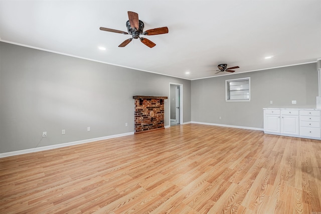 unfurnished living room with ceiling fan, light hardwood / wood-style floors, and crown molding