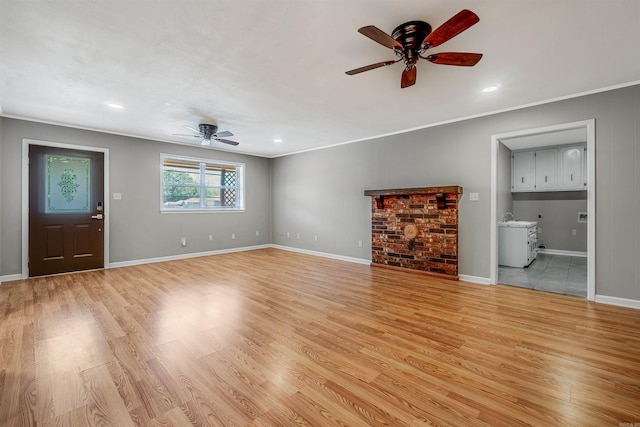 unfurnished living room with light hardwood / wood-style floors and ornamental molding