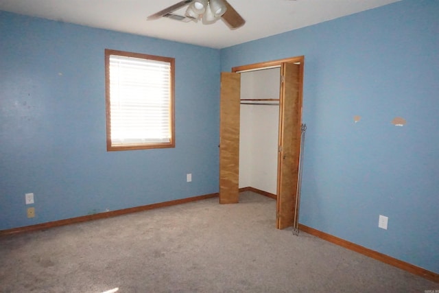 unfurnished bedroom featuring light colored carpet, a closet, and ceiling fan