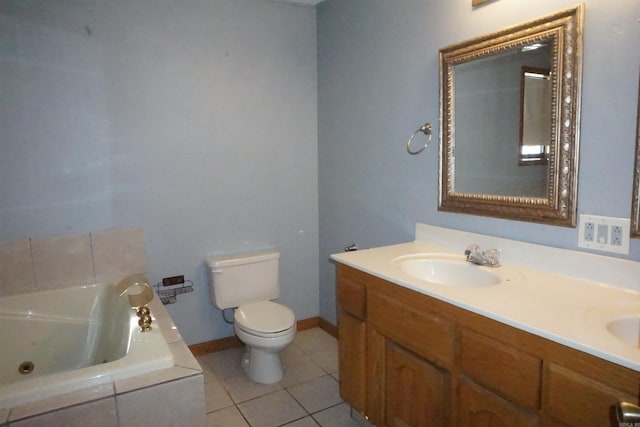 bathroom featuring toilet, vanity, tile patterned floors, and tiled bath