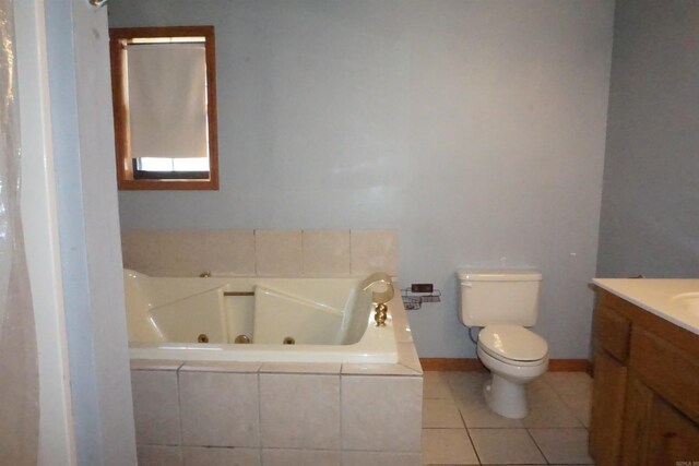 bathroom with vanity, tiled bath, toilet, and tile patterned floors