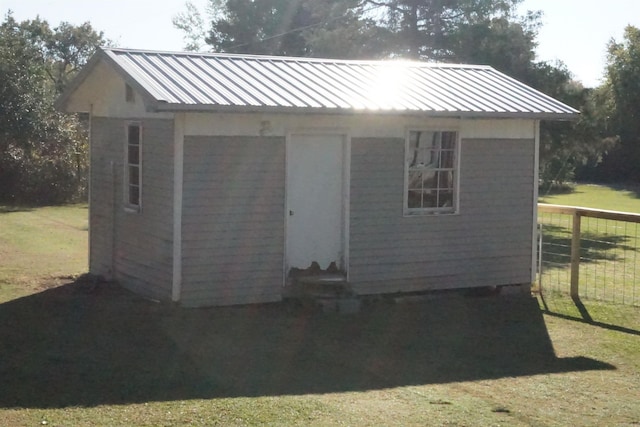 view of outbuilding with a yard