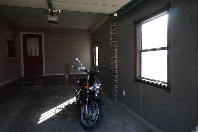 workout room featuring concrete floors and plenty of natural light