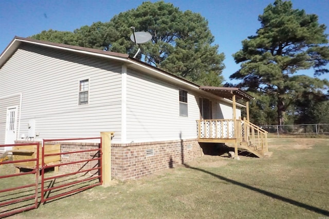 view of side of home with a yard