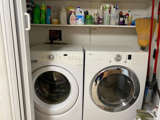 clothes washing area with separate washer and dryer