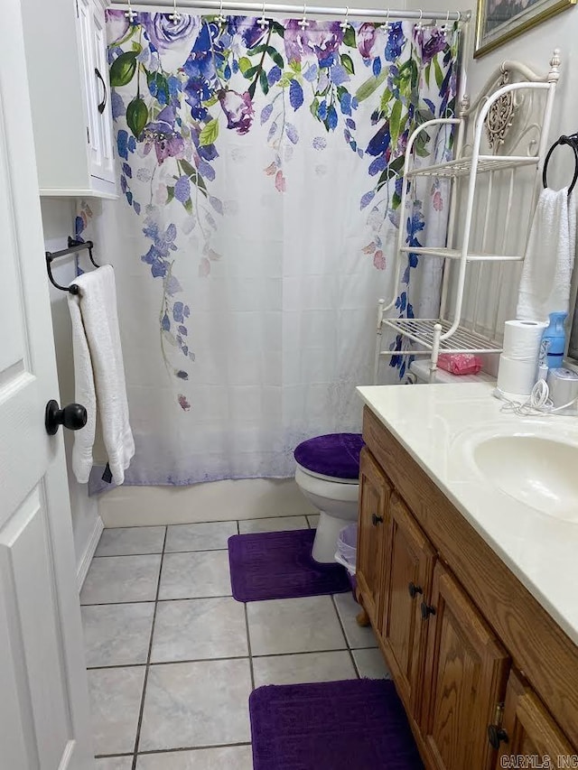 full bathroom featuring vanity, shower / bath combo with shower curtain, toilet, and tile patterned flooring