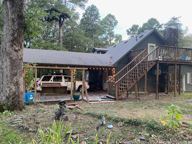 rear view of house featuring a carport and a deck