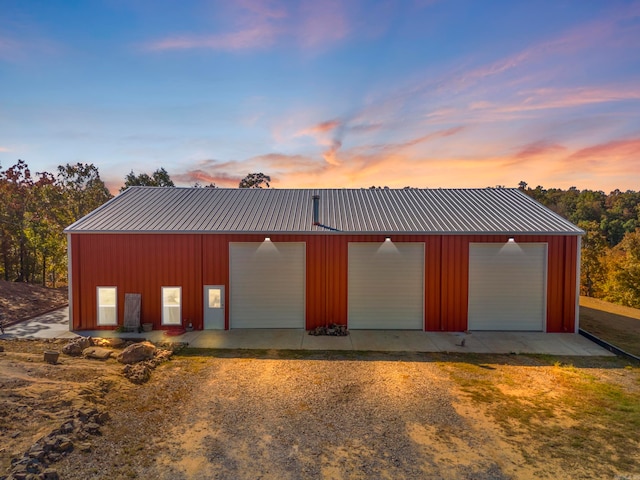 view of garage at dusk