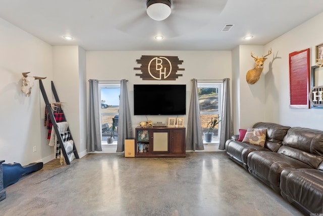 living room with concrete floors and a healthy amount of sunlight