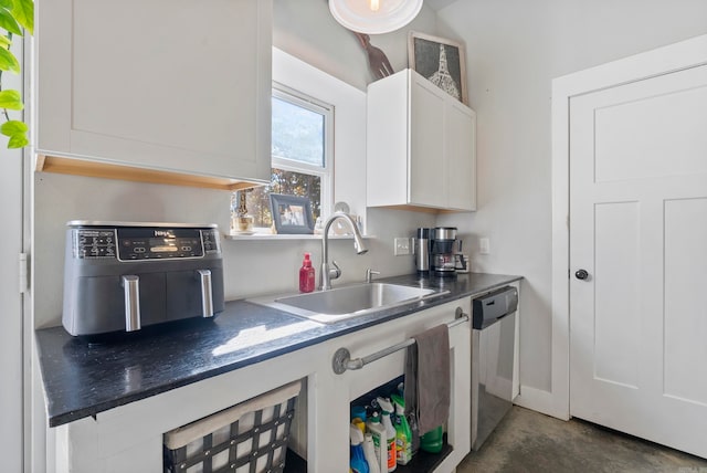 kitchen with stainless steel dishwasher, white cabinetry, and sink