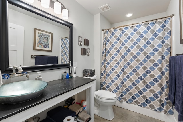 bathroom featuring toilet, curtained shower, and vanity